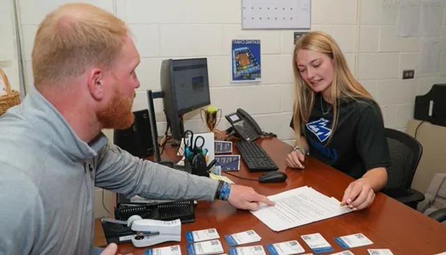 student and staff sorting tickets